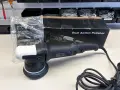 En ny arcticlean polermaskin, redo att ge glans åt din bil. Den ligger bredvid sin förpackning, med en påse med tillbehör.