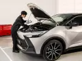 Mekaniker fyller på olja i en Toyota C-HR. För bästa service och pris på din Toyota Yaris, besök oss.