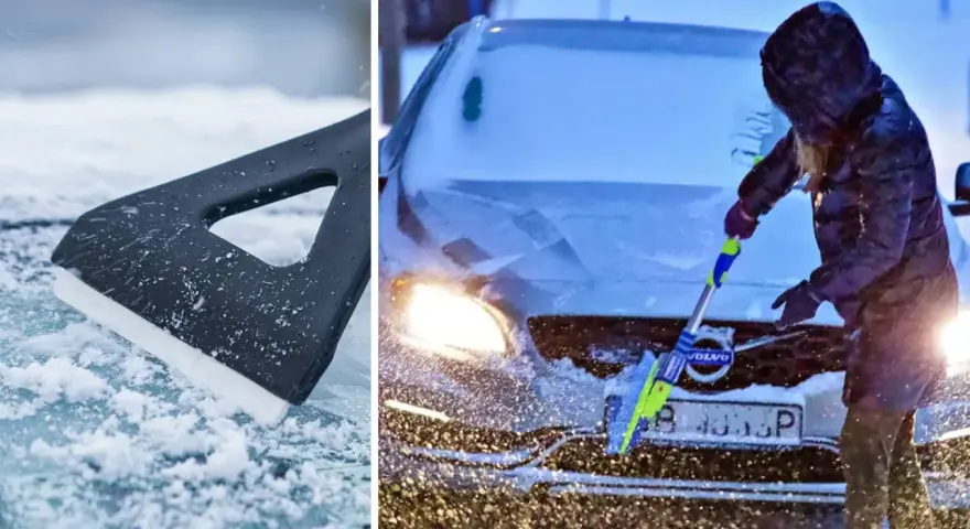 En person med huva skrapar rutan på en Volvo i snöstorm. En isskrapa ligger på isig mark.