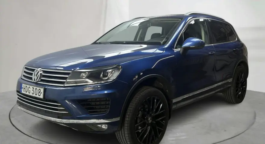 Blå VW Touareg med svarta fälgar. En bil med ett potentiellt vw touareg problem, står på en snurrplatta i en studio.