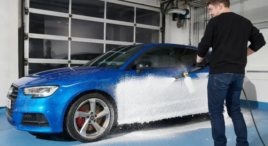 Man skummar en blå bil med Autoglym Polar Blast.